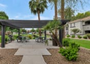Thumbnail 31 of 36 - A park with a pavilion, benches, and trees at Montage at Pecos Ranch Apartments, Chandler, Arizona