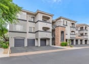 Thumbnail 33 of 36 - a street view of an apartment building with garage doors at Montage at Pecos Ranch Apartments, Chandler, 85286