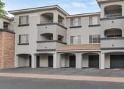 Thumbnail 34 of 36 - A large white building with a red tile roof and multiple balconies at Montage at Pecos Ranch Apartments, Chandler, Arizona