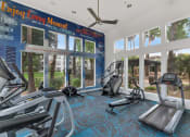 Thumbnail 4 of 36 - a gym with cardio equipment and windows at the resort at longboat key club at Montage at Pecos Ranch Apartments, Chandler, 85286