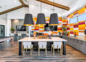 Thumbnail 18 of 76 - a dining room with a table and chairs in front of a kitchenat Weylyn Luxury Apartments, Laveen, 85339