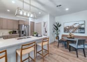 Thumbnail 30 of 76 - a kitchen and dining room with a table and chairs at Weylyn Luxury Apartments, Laveen, Arizona