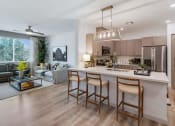 Thumbnail 32 of 76 - a kitchen and living room in an open floor planat Weylyn Luxury Apartments, Laveen, AZ
