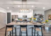 Thumbnail 37 of 76 - a kitchen with a large island with three stools at Weylyn Luxury Apartments, Arizona