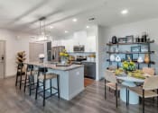 Thumbnail 38 of 76 - a kitchen and dining room with a table and chairsat Weylyn Luxury Apartments, Laveen, AZ 85339