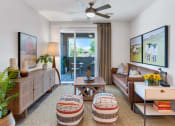 Thumbnail 39 of 76 - a living room with a couch and a ceiling fanat Weylyn Luxury Apartments, Laveen, AZ