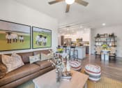 Thumbnail 40 of 76 - a living room with a couch and a tableat Weylyn Luxury Apartments, Arizona