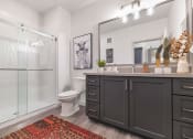 Thumbnail 42 of 76 - a bathroom with a shower and a toilet and a sink at Weylyn Luxury Apartments, Laveen, 85339