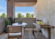 Thumbnail 46 of 76 - a patio with a table and chairs and a large window at Weylyn Luxury Apartments, Laveen, 85339