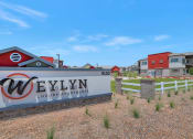 Thumbnail 69 of 76 - a sign luxury apartments with houses in the background at Weylyn Luxury Apartments, Laveen, Arizona