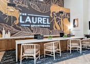 Thumbnail 17 of 51 - A conference room with a large table and chairs with a backdrop that says  at The Laurel Apartments, Chandler  
