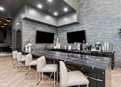 Thumbnail 24 of 51 - A modern kitchen with a marble countertop and bar stools at The Laurel Apartments, Arizona  .
