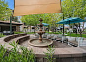 Thumbnail 45 of 51 - A fountain in the middle of a patio with a shade sail over it. at The Laurel Apartments, Chandler, AZ  