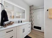 Thumbnail 8 of 51 - A bathroom with a white vanity and a mirror above it at The Laurel Apartments, Chandler, AZ  .