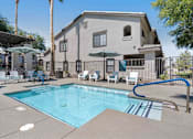 Thumbnail 30 of 40 - A swimming pool in front of a house with a blue tiled edge. at Lazo Apartment Homes, Arizona, 85225