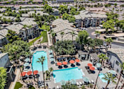 Thumbnail 1 of 40 - A pool surrounded by palm trees and umbrellas. at Lazo Apartment Homes, Arizona, 85225