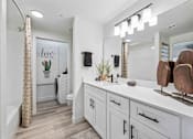 Thumbnail 11 of 40 - A bathroom with a white vanity and a shower area. at Lazo Apartment Homes, Chandler, AZ 85225  