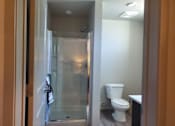 Thumbnail 9 of 14 - Bathroom with glass shower and modern finishes at Pinon Lofts Apartments, Sedona