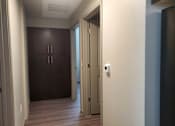 Thumbnail 10 of 14 - Hallway with wood flooring and builtin storage at Pinon Lofts Apartments, Arizona, 86336