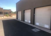 Thumbnail 11 of 14 - Three car garage doors with individual access at Pinon Lofts Apartments, Sedona, AZ 86336