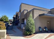 Thumbnail 3 of 14 - Modern apartment buildings with courtyard walkway at Pinon Lofts Apartments, Sedona, 86336