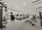 Thumbnail 9 of 26 - Spacious gym with cardio and strength training machines at Lucero Apartments, Phoenix, AZ