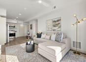 Thumbnail 16 of 26 - Open concept living room with modern furnishings at Lucero Apartments, Arizona
