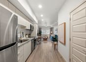 Thumbnail 14 of 26 - Open layout kitchen with stainless steel appliances at Lucero Apartments, Phoenix, 85051