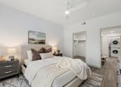 Thumbnail 19 of 26 - Bedroom with walk-in closet and laundry access at Lucero Apartments, Phoenix, Arizona