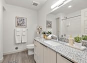 Thumbnail 20 of 26 - Bright bathroom with white subway tile and granite vanity at Lucero Apartments, Phoenix, AZ 85051