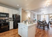 Thumbnail 3 of 42 - A kitchen with black appliances and white cabinets.at Palazzo Townhomes, Arizona, 85008