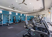 Thumbnail 30 of 42 - A gym with a row of treadmills and exercise equipment.at Palazzo Townhomes, Phoenix Arizona  