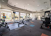 Thumbnail 32 of 42 - A gym with a variety of equipment including treadmills, elliptical machines, and weights.at Palazzo Townhomes, Phoenix Arizona  