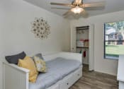 Thumbnail 10 of 34 - A bedroom with a bed, a ceiling fan, and a window at Reflections at Red Mountain Apartments, Arizona, 85213