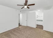 Thumbnail 10 of 26 - A room with a ceiling fan and carpeted floor at The Phoenix Apartments on 6th Avenue, Phoenix, Arizona