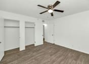 Thumbnail 12 of 26 - A room with a ceiling fan and wooden flooring at The Phoenix Apartments on 6th Avenue, Phoenix, AZ