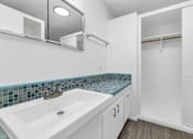 Thumbnail 16 of 26 - A white bathroom with a sink and a mirror at The Phoenix Apartments on 6th Avenue, Arizona 85013