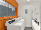 Thumbnail 17 of 26 - A clean, white-walled laundry room with a washer and dryer at The Phoenix Apartments on 6th Avenue, Arizona