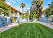 Thumbnail 18 of 26 - A row of houses with blue fences and green lawns at The Phoenix Apartments on 6th Avenue, Phoenix, Arizona