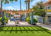 Thumbnail 23 of 26 - A sunny day at a park with a picnic table and a wooden pergola at The Phoenix Apartments on 6th Avenue, Phoenix, AZ