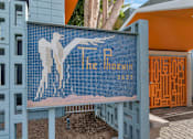Thumbnail 26 of 26 - A blue tiled mosaic of a man holding a bird with the words at The Phoenix Apartments on 6th Avenue, Arizona