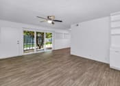 Thumbnail 8 of 26 - A room with a ceiling fan and wooden flooring at The Phoenix Apartments on 6th Avenue, Arizona 85013