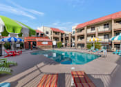 Thumbnail 1 of 36 - A pool area with a red and white striped pool mat. at Urban WalkApartments on 6th Avenue, Phoenix, Arizona