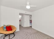 Thumbnail 9 of 36 - A room with a ceiling fan and a round chair with a red pillow at Urban WalkApartments on 6th Avenue, Phoenix, Arizona