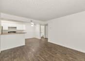 Thumbnail 15 of 36 - A room with wooden flooring and white walls at Urban WalkApartments on 6th Avenue, Phoenix, AZ
