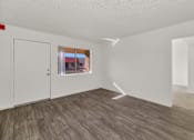 Thumbnail 16 of 36 - A room with a wooden floor and white walls. at Urban WalkApartments on 6th Avenue, Arizona 85016