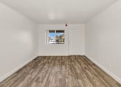 Thumbnail 22 of 36 - A room with a white door and a window with a view of trees and a house at Urban WalkApartments on 6th Avenue, Phoenix, AZ