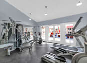 Thumbnail 27 of 36 - A gym with a variety of equipment including treadmills, stationary bikes, and weight machines at Urban WalkApartments on 6th Avenue, Phoenix 85016