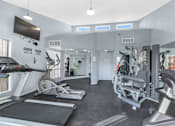 Thumbnail 28 of 36 - A gym with treadmills, weights, and exercise equipment at Urban WalkApartments on 6th Avenue, Arizona 85016