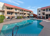 Thumbnail 33 of 36 - A swimming pool in front of apartment buildings at Urban WalkApartments on 6th Avenue, Phoenix